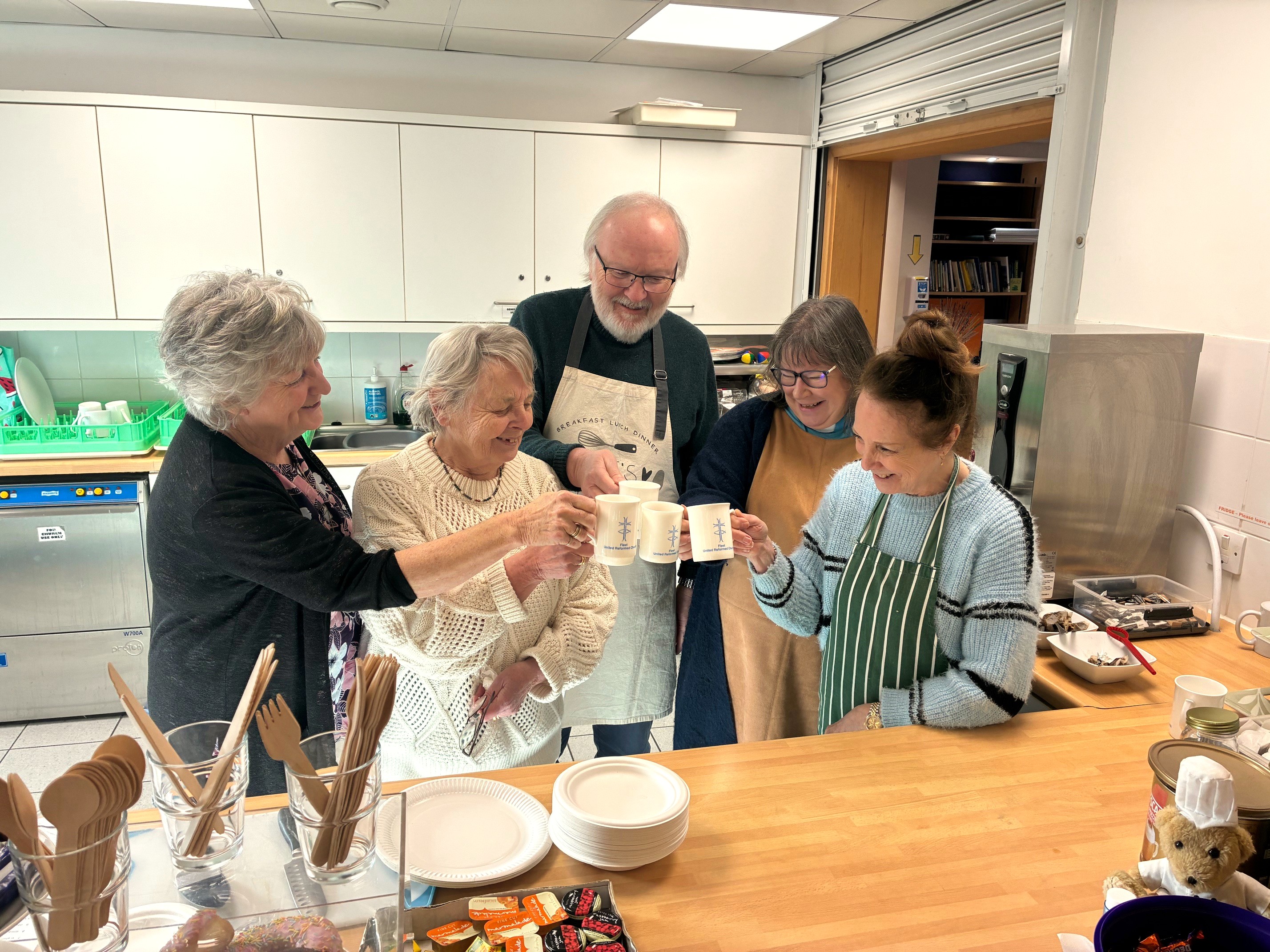 Group share a cup of tea at fundraising coffee morning