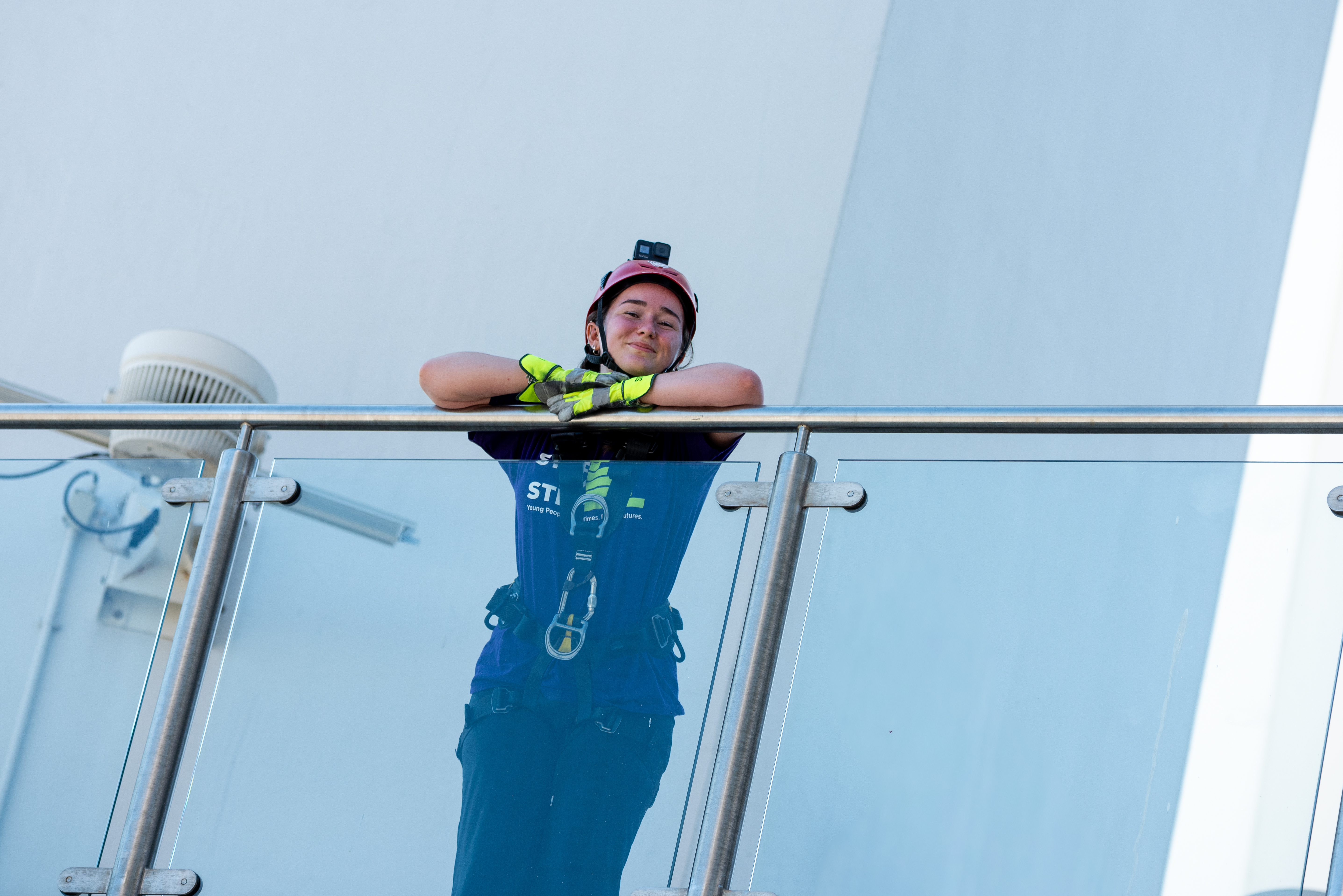 Young woman prepares to abseil Spinnaker Tower