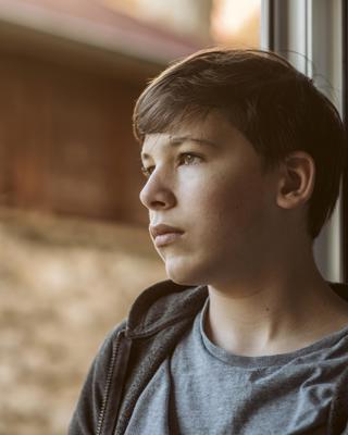 Side View Sad Boy Looking Outside