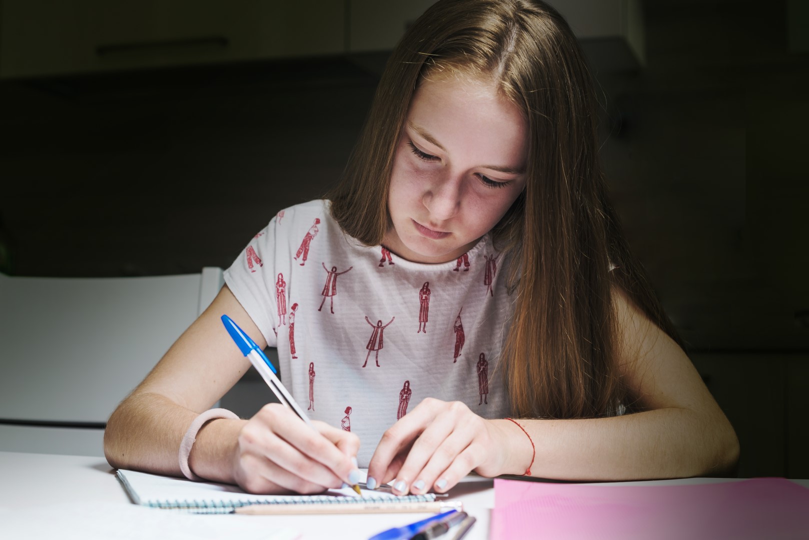 Fostering Girl Doing Homework Table