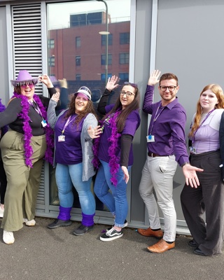 Staff Step Into Purple