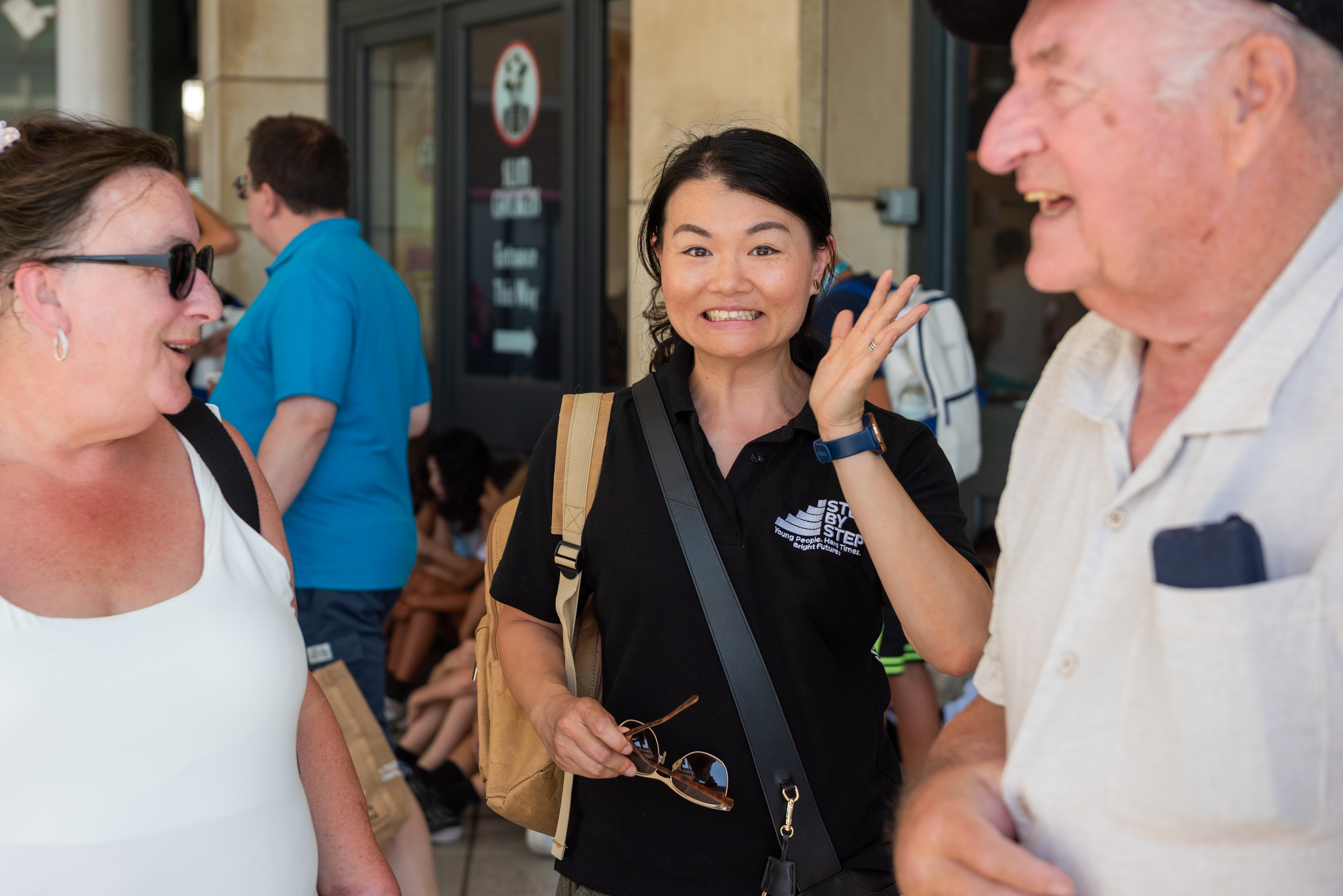 Young woman smiles at camera during fundraising event